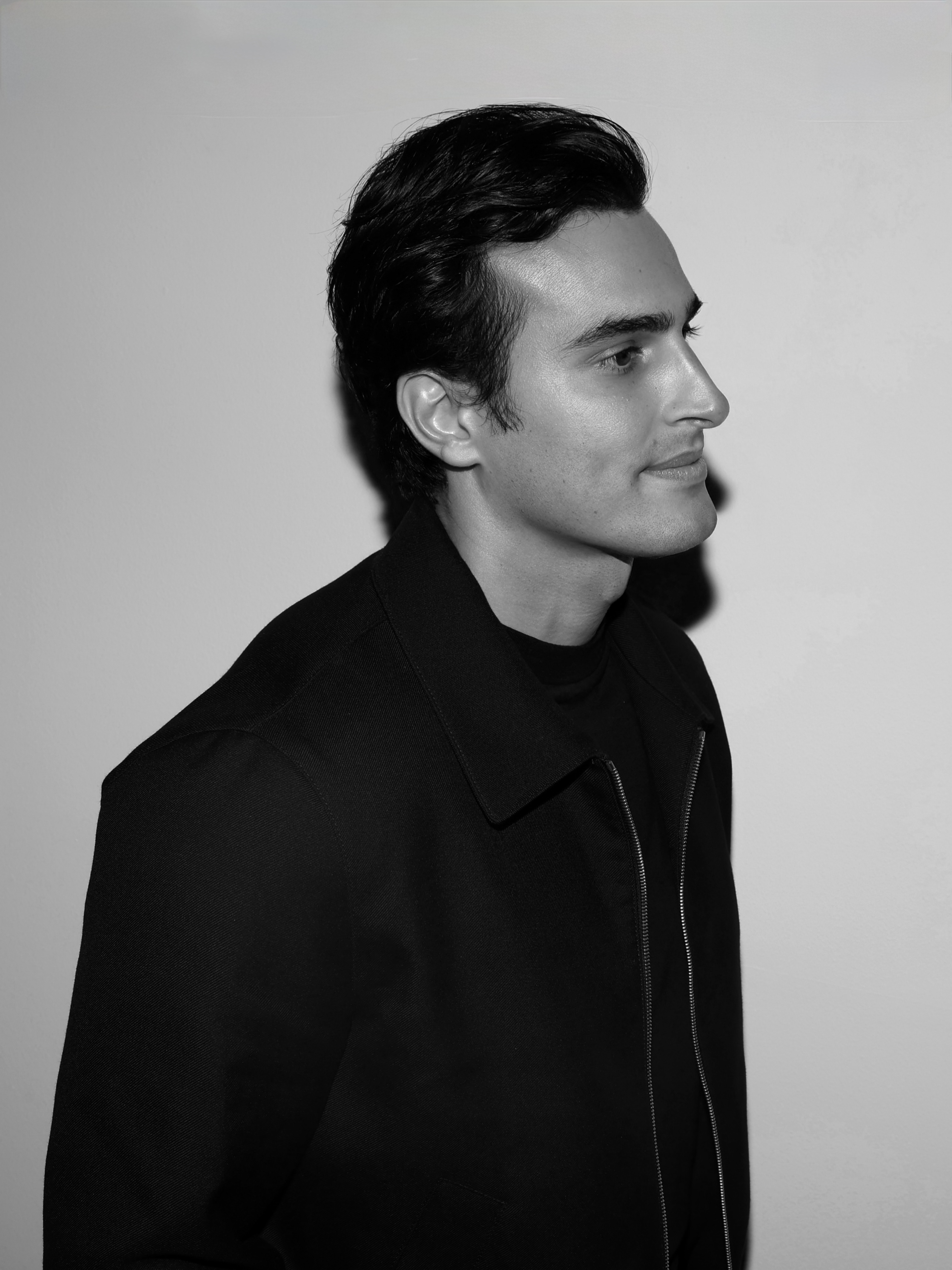 Ali Hennaoui, Dubai-based luxury fashion filmmaker and creative director, editorial portrait in black and white. GQ Middle East cover 2026.